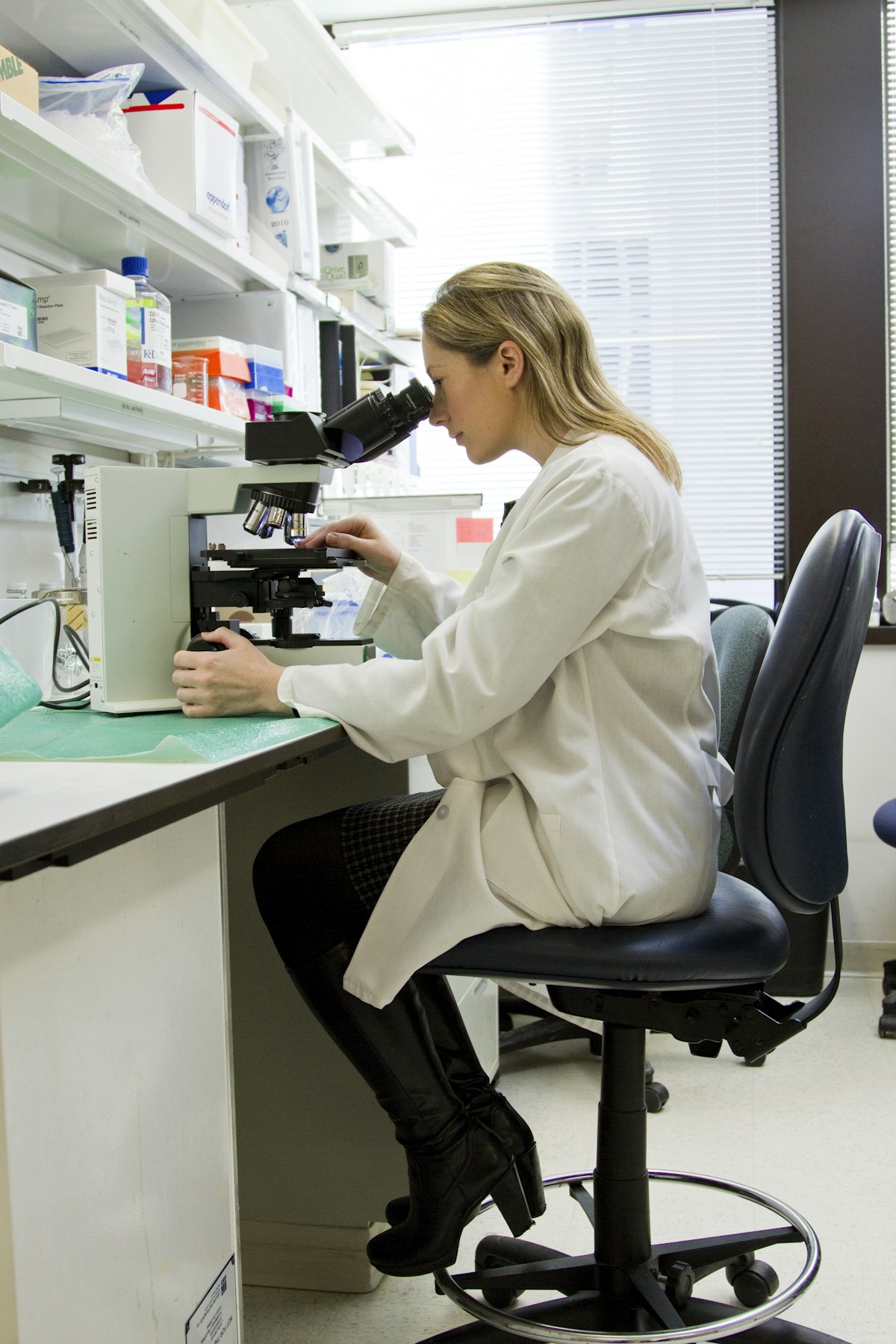 A person reviewing medical records and lab results at a desk
